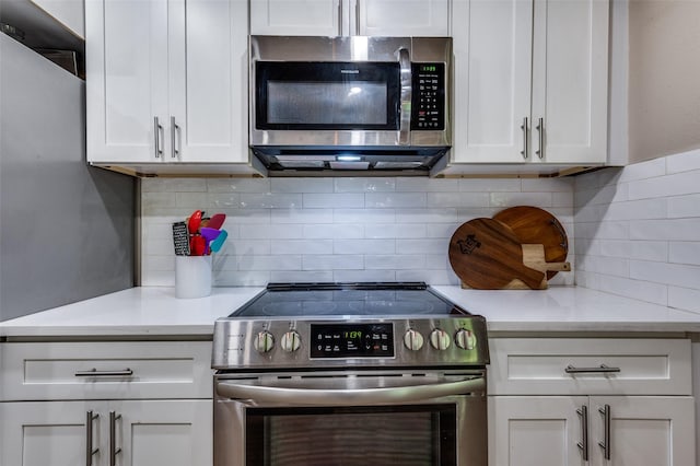 3467 Navajo Cir, Dallas, TX 75224 - kitchen with appliances with stainless steel finishes, white cabinets, and backsplash
