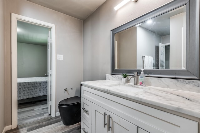3467 Navajo Cir, Dallas, TX 75224 - ensuite bathroom featuring wood finished floors and vanity