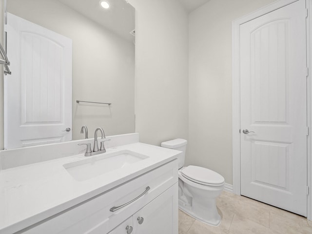bathroom with vanity, recessed lighting, tile patterned floors, and toilet