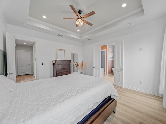 bedroom featuring a raised ceiling, light wood-type flooring, recessed lighting, and visible vents