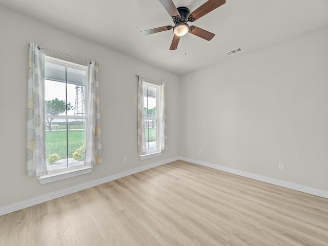 12530 Doyle Rd, Krum, TX 76249 - empty room with visible vents, baseboards, ceiling fan, and wood finished floors