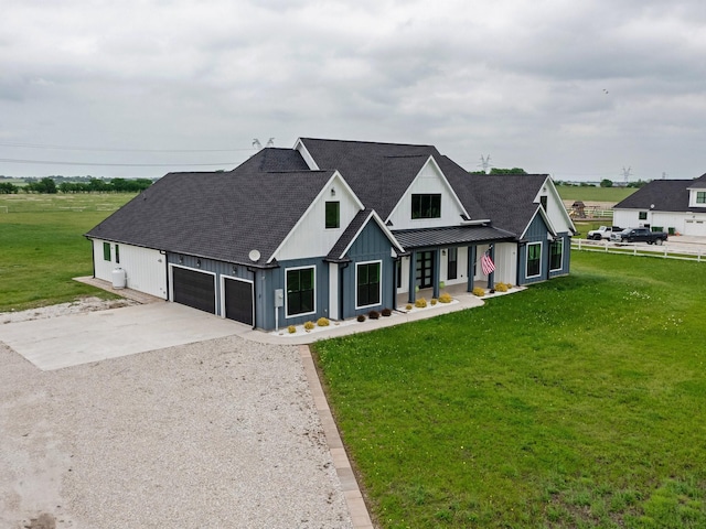 modern farmhouse featuring a front lawn, board and batten siding, roof with shingles, and concrete driveway