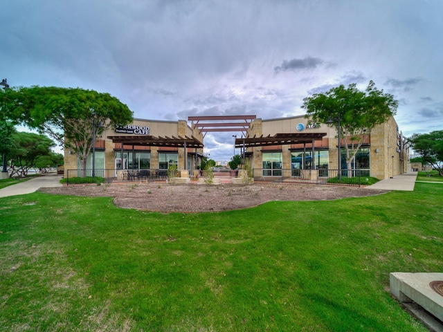 back of property featuring a pergola, fence, and a yard