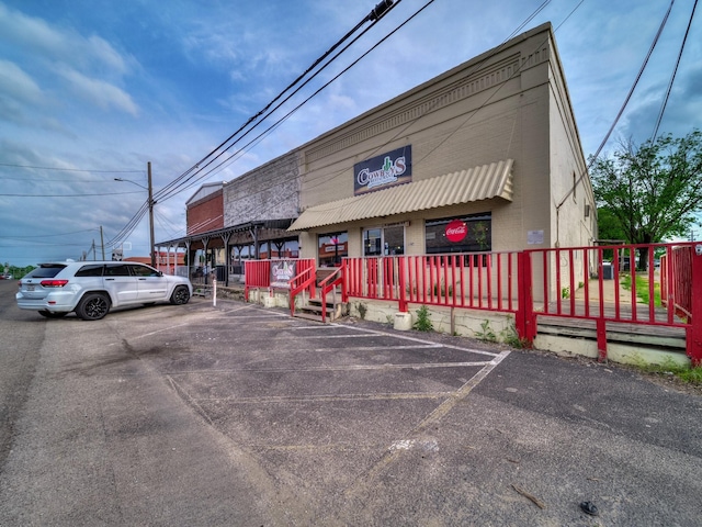 view of building exterior featuring uncovered parking