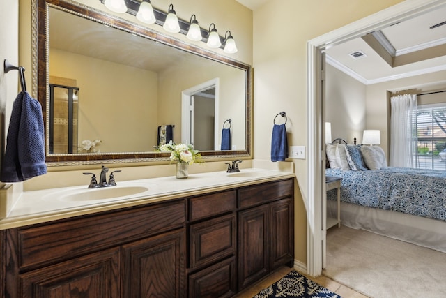 ensuite bathroom with a sink, crown molding, ensuite bath, and visible vents
