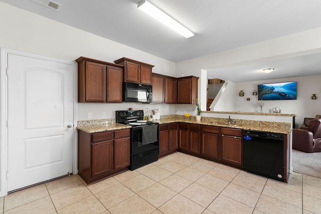 1320 Corkwood Dr, Princeton, TX 75407 - kitchen featuring light tile patterned floors, a sink, black appliances, a peninsula, and open floor plan