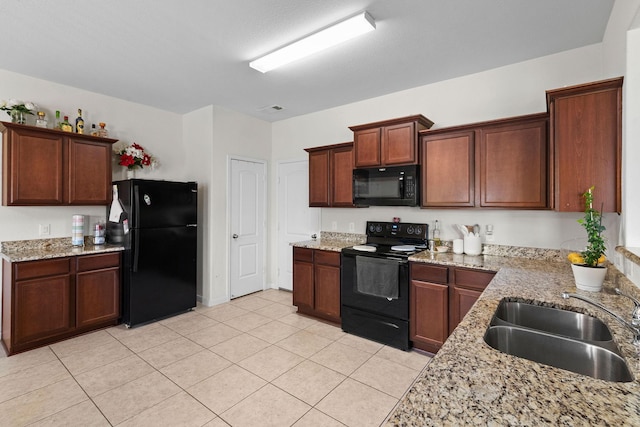 1320 Corkwood Dr, Princeton, TX 75407 - kitchen featuring light tile patterned floors, light stone countertops, a sink, and black appliances