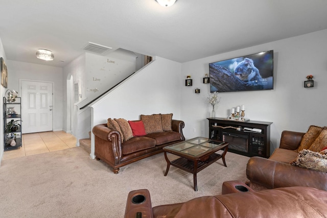 1320 Corkwood Dr, Princeton, TX 75407 - living area featuring stairs, light colored carpet, visible vents, and light tile patterned floors