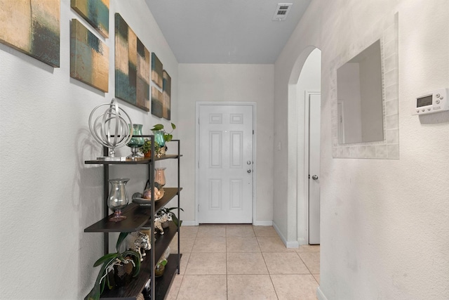 1320 Corkwood Dr, Princeton, TX 75407 - doorway to outside with light tile patterned floors, arched walkways, baseboards, and visible vents