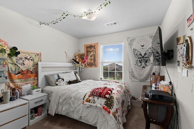 1320 Corkwood Dr, Princeton, TX 75407 - bedroom featuring dark carpet, a textured ceiling, and visible vents