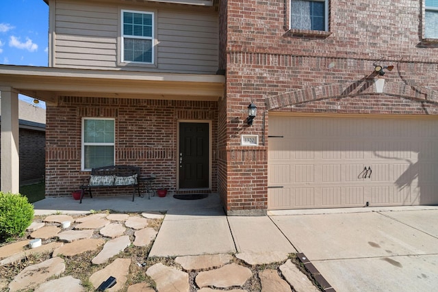 1320 Corkwood Dr, Princeton, TX 75407 - property entrance with brick siding, an attached garage, and driveway