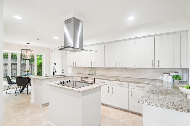 kitchen with a peninsula, recessed lighting, black electric cooktop, island exhaust hood, and a sink