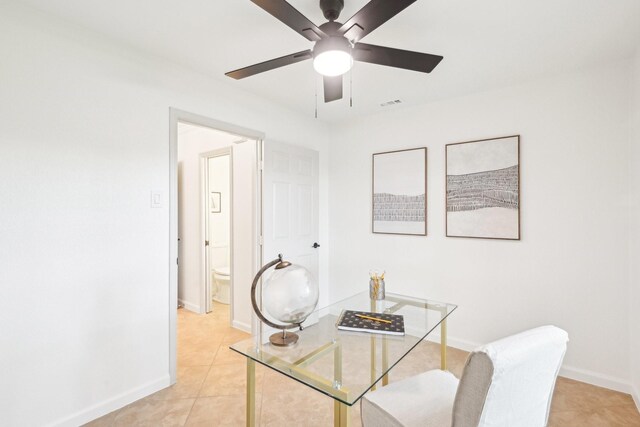 office featuring baseboards, a ceiling fan, light tile patterned floors, and visible vents