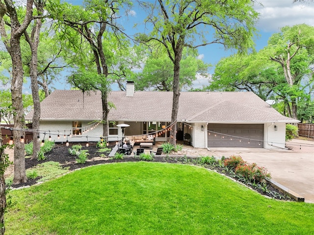 ranch-style house featuring a chimney, a garage, fence, a front lawn, and concrete driveway