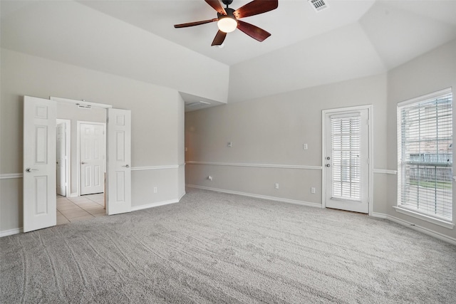 carpeted empty room featuring baseboards, ceiling fan, visible vents, and lofted ceiling