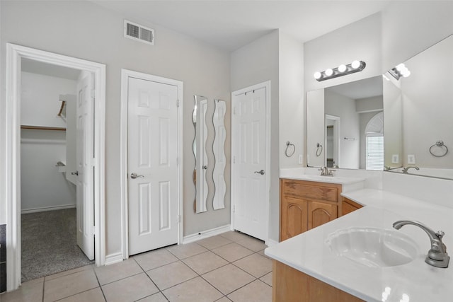 full bath with visible vents, a sink, tile patterned flooring, and double vanity