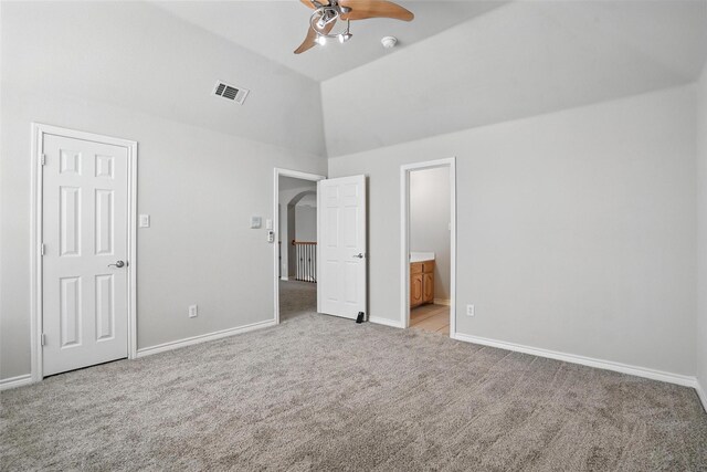 unfurnished bedroom featuring light colored carpet, high vaulted ceiling, visible vents, and baseboards