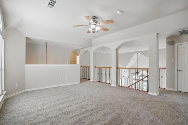 unfurnished room with a ceiling fan, visible vents, and carpet