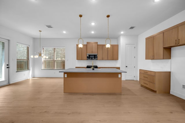 17546 Sequoia Dr, Dallas, TX 75252 - kitchen with decorative light fixtures, stainless steel microwave, visible vents, and light wood-style flooring