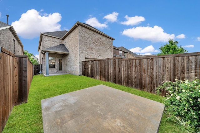 17546 Sequoia Dr, Dallas, TX 75252 - rear view of house featuring roof with shingles, brick siding, a fenced backyard, a yard, and a patio