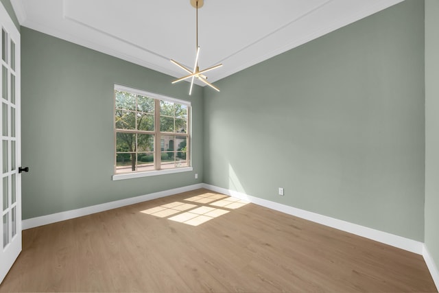 17546 Sequoia Dr, Dallas, TX 75252 - unfurnished room featuring crown molding, baseboards, wood finished floors, and a notable chandelier