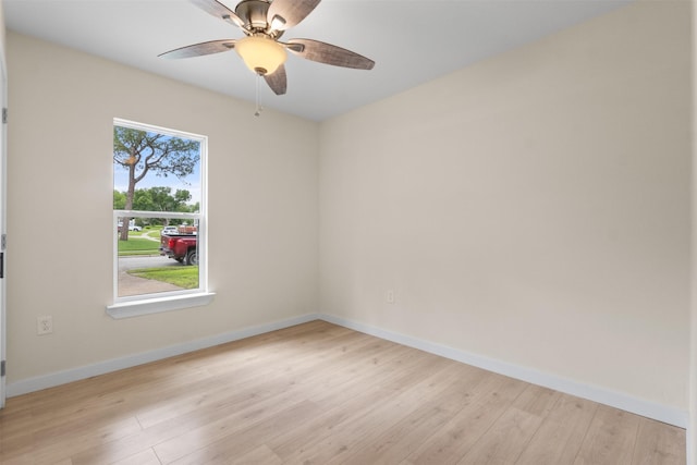 unfurnished room with a ceiling fan, light wood-type flooring, and baseboards