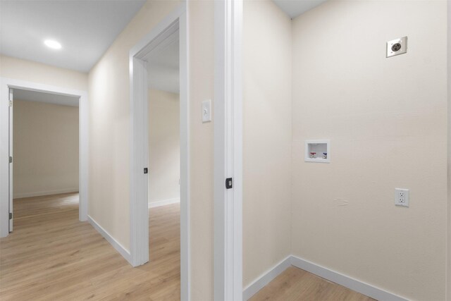 corridor featuring light wood-style floors and baseboards
