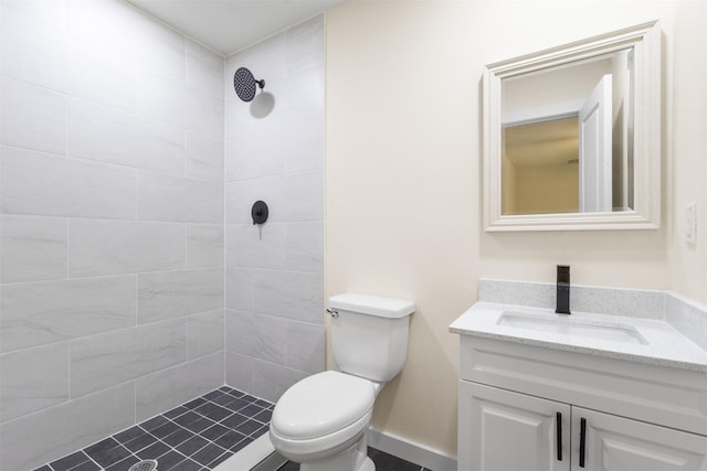full bathroom featuring vanity, toilet, and a tile shower