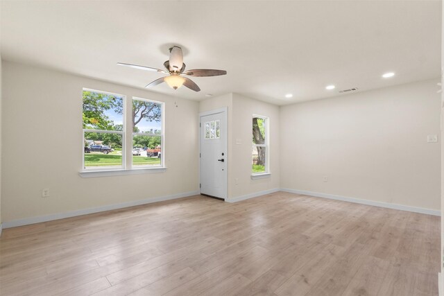 empty room featuring a ceiling fan, light wood-type flooring, recessed lighting, and baseboards