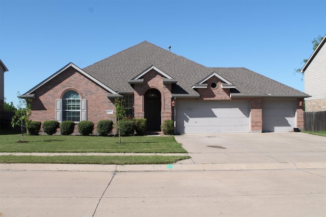 2005 Sumac Dr, Forney, TX 75126 - view of front of house with brick siding, concrete driveway, a garage, and a shingled roof
