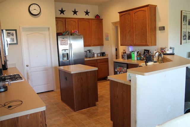 2005 Sumac Dr, Forney, TX 75126 - kitchen with stainless steel appliances, a peninsula, light countertops, and brown cabinetry
