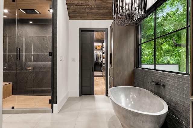 4280 Shorecrest Dr, Dallas, TX 75209 - full bathroom with a shower stall, a freestanding bath, tile patterned flooring, and a chandelier