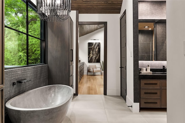 4280 Shorecrest Dr, Dallas, TX 75209 - bathroom with a freestanding tub, vanity, a chandelier, tile patterned floors, and wooden ceiling