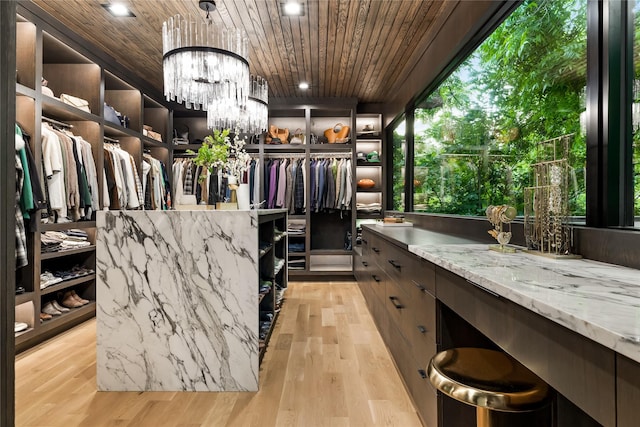 4280 Shorecrest Dr, Dallas, TX 75209 - spacious closet with light wood-type flooring and a chandelier