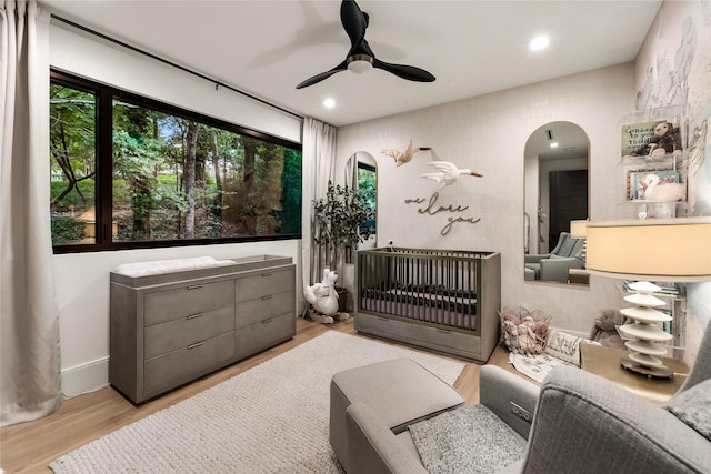 4280 Shorecrest Dr, Dallas, TX 75209 - bedroom featuring wood finished floors, a nursery area, arched walkways, a ceiling fan, and recessed lighting
