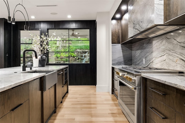 4280 Shorecrest Dr, Dallas, TX 75209 - kitchen featuring high end stainless steel range oven, light wood-style flooring, light stone counters, backsplash, and recessed lighting