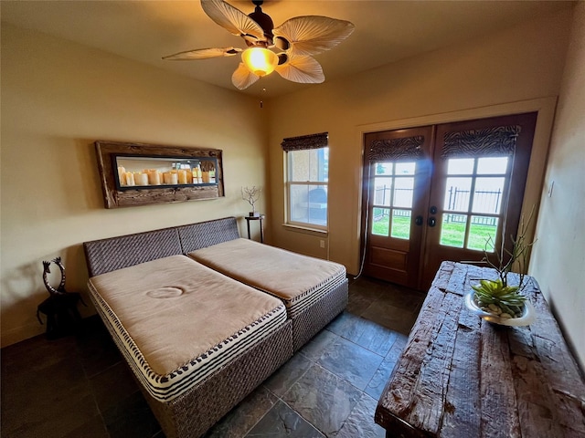 bedroom with french doors, a ceiling fan, access to outside, and stone tile flooring