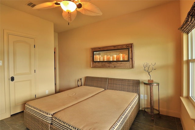 bedroom featuring baseboards, a ceiling fan, and visible vents