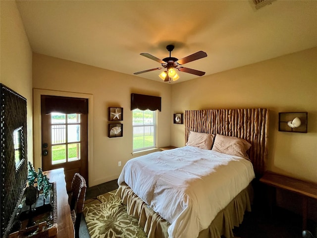 bedroom featuring multiple windows, ceiling fan, and visible vents
