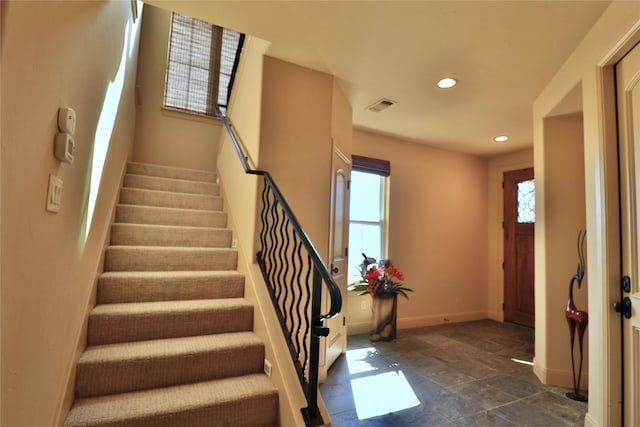 entryway featuring a wealth of natural light, recessed lighting, stairs, and visible vents