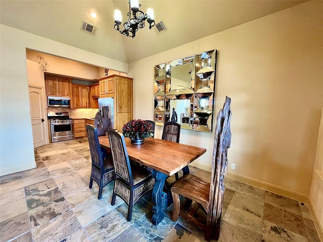 dining area featuring an inviting chandelier, baseboards, stone finish floor, and visible vents