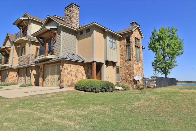 view of building exterior with concrete driveway, fence, and a garage