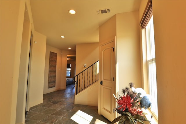 entryway with stone finish floor, visible vents, stairway, baseboards, and recessed lighting