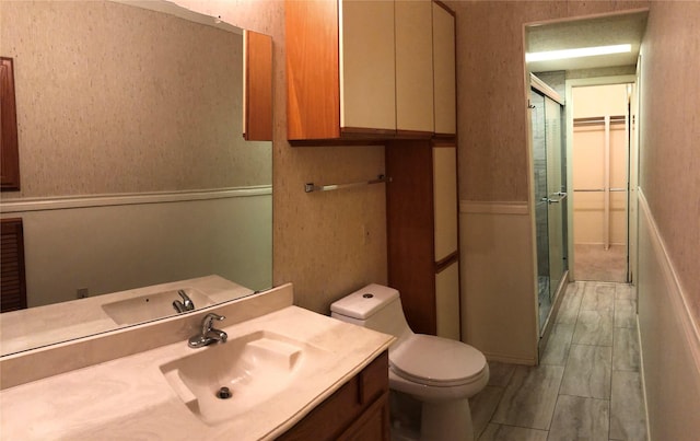 full bath featuring vanity, a stall shower, and toilet