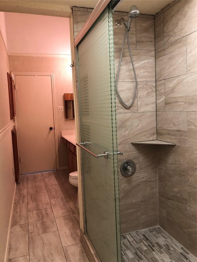bathroom featuring vanity, toilet, tile patterned floors, and a stall shower