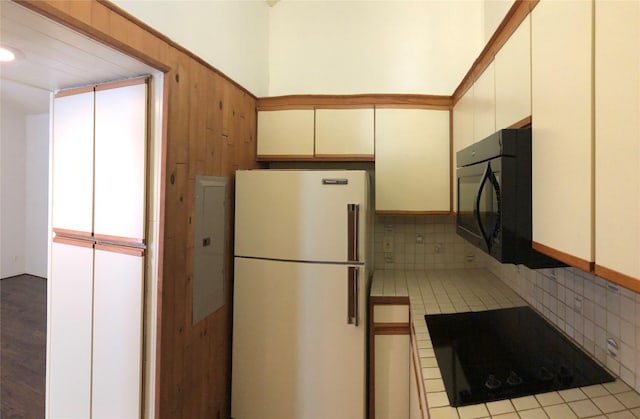 kitchen featuring tile patterned flooring, black appliances, tile countertops, and cream cabinetry