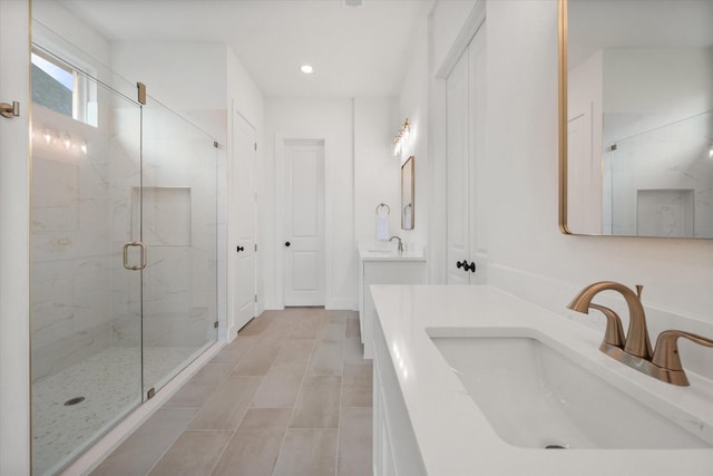 full bathroom with a marble finish shower, tile patterned flooring, vanity, and recessed lighting