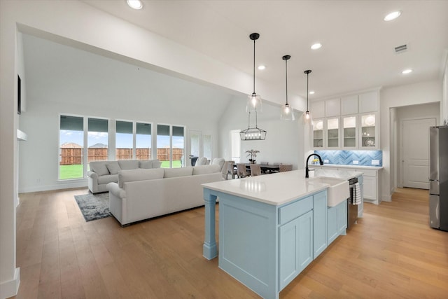 kitchen with a sink, white cabinetry, appliances with stainless steel finishes, and tasteful backsplash