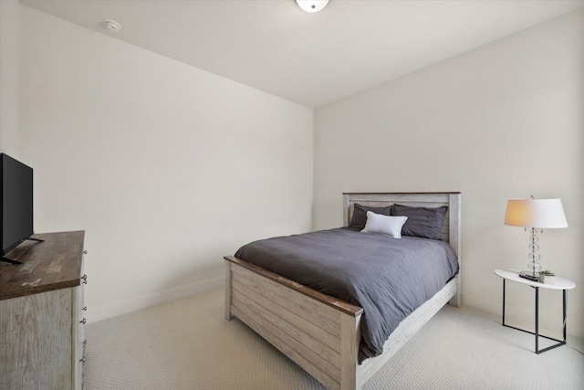bedroom with baseboards and carpet