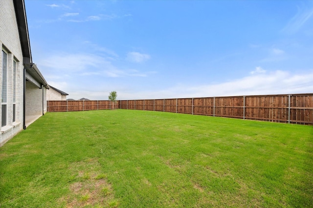 view of yard with a fenced backyard